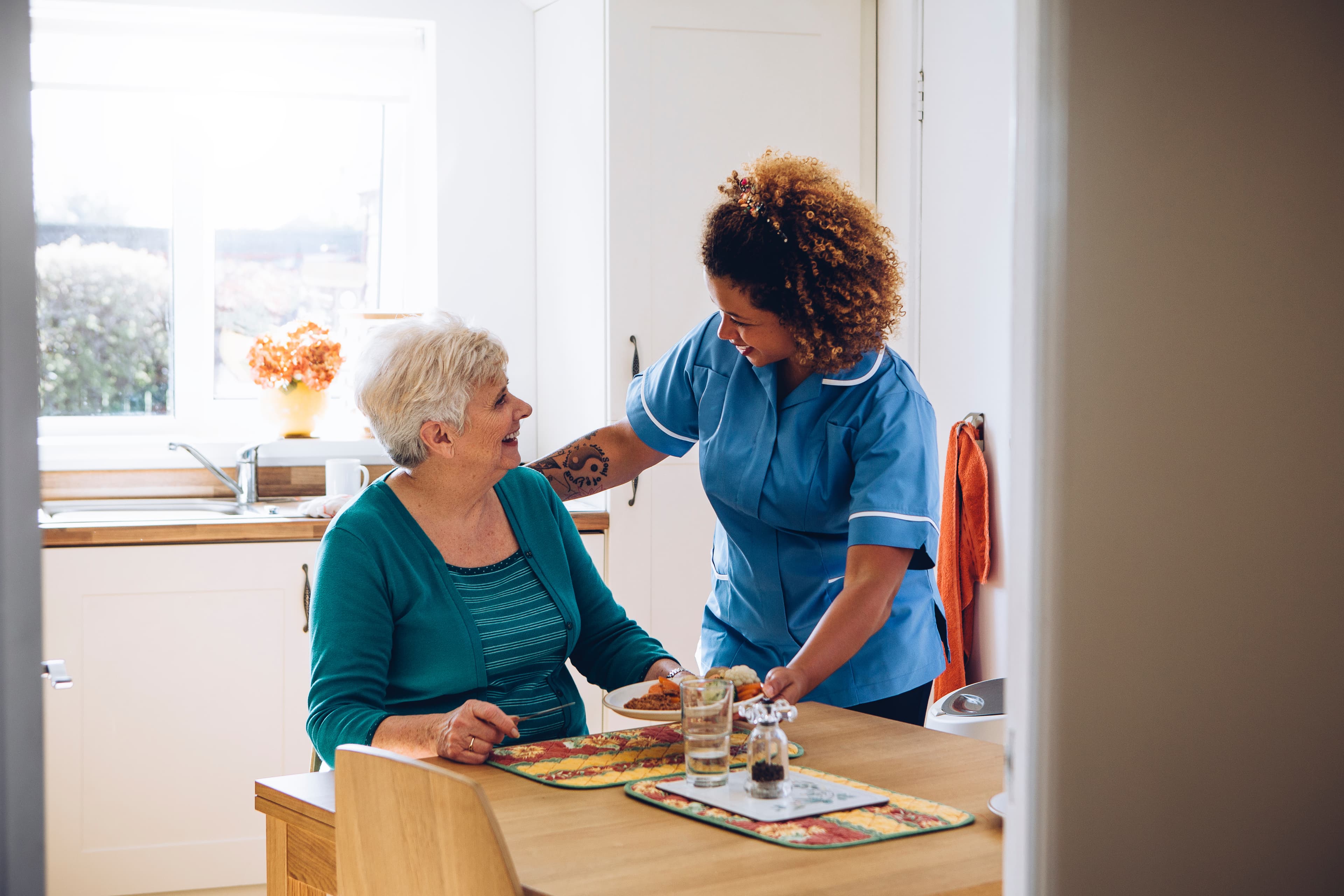 Carer helping elderly woman